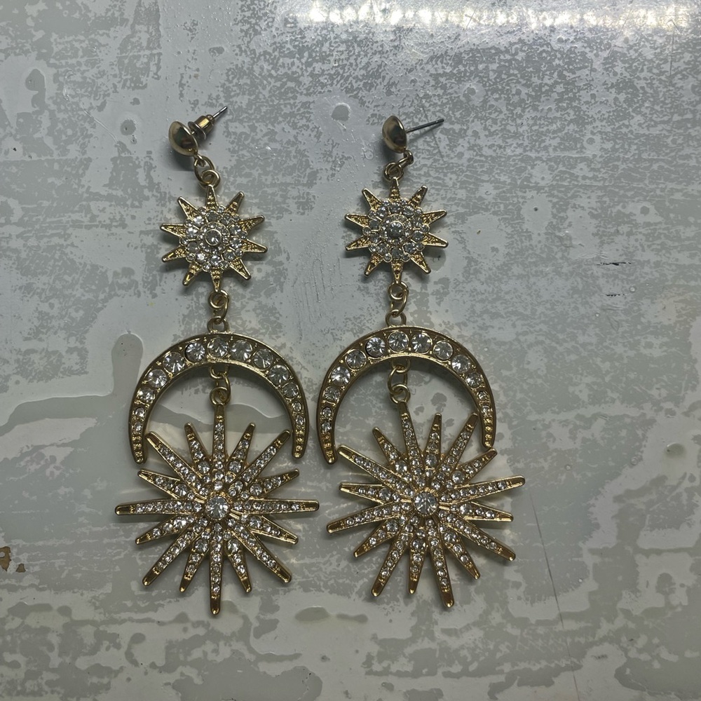 Gold colored star drop earrings